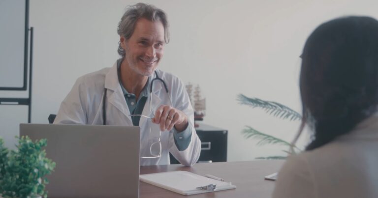 Doctor sitting in his office with a patient.